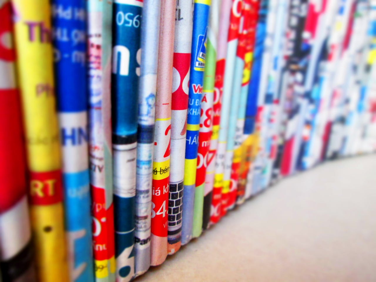 The Art of Drawing Readers In: Your attractive post title goes here Vibrant, assorted rolled magazines create a colorful display.